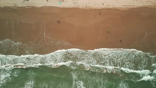 Aerial Above Shot of Sand Beach on a Summer Day While Turquiose Sea Waves Breaking on Coastline