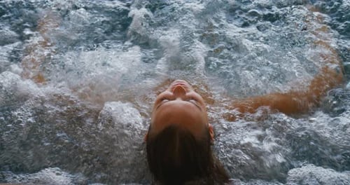 Close up of an young female is enjoying and having relax in a bath tube in a luxury wellness cente