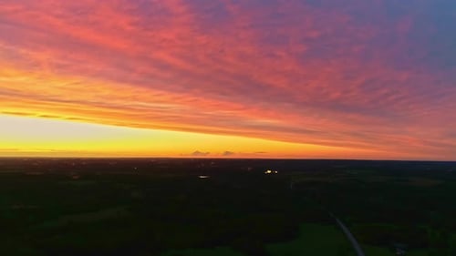 Aerial view during colorful golden hour sunset with clouds