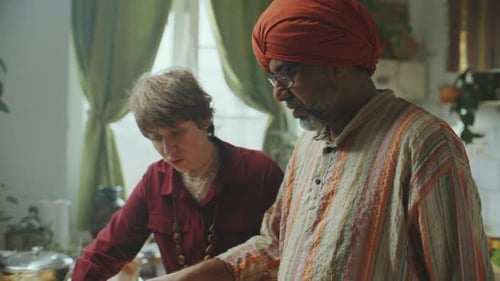 Two People Cooking Food Indoors