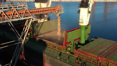 Aerial of Wheat Loading to Bulker Ship Cargo Hold at Sea Grain Elevator in Sea Port Wheat Pouring