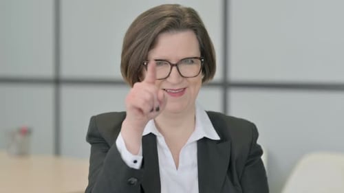 Portrait of Old Businesswoman Pointing at the Camera