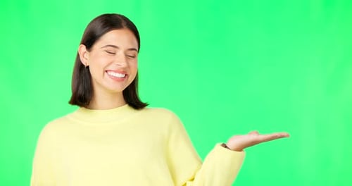 Happy woman, face and hand on green screen for product placement, advertising
