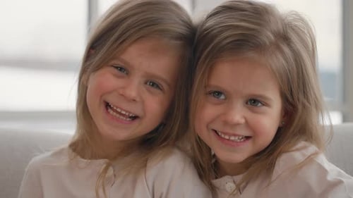 Two Charming Girls Laughing Together Indoors
