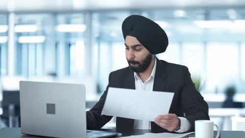 Man Working at Laptop in Modern Office
