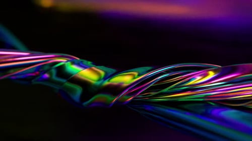 Ribbons of a Metallic Rainbow Color are Tightly Twisted Together Against an Abstract Background
