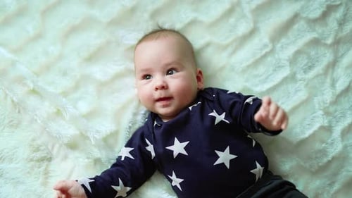 Adorable Baby Lying on Soft Blanket Close Up