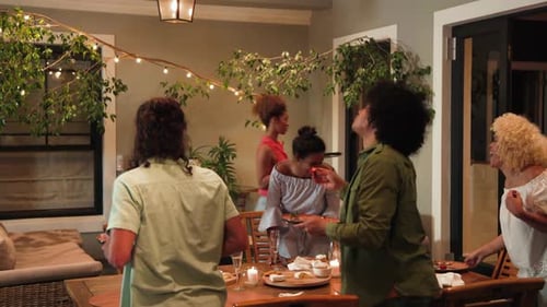 Friends Prepare Food at Garden Party at Night