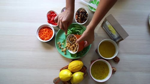 Preparing Fresh Salad with Chickpeas and Vegetables