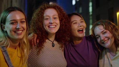 Happy Young Adult Friends Laughing Together at Night