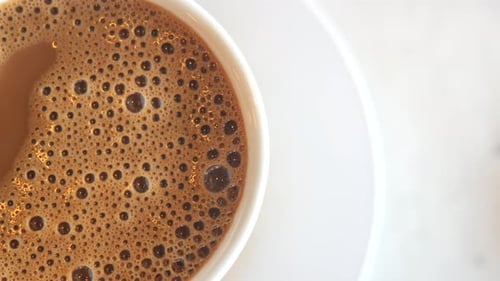 Top View of Hot Coffee with Bubble on White Background