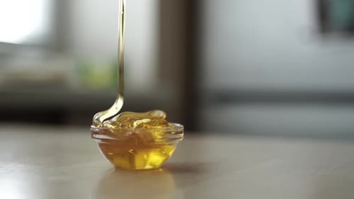 honey dripping from spoon