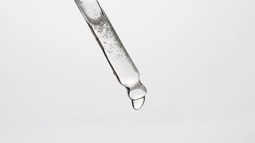 Liquid Drops Falling From Glass Dropper