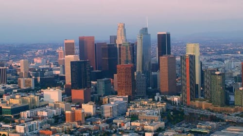Golden hour helicopter flight around downtown Los Angeles skyscrapers at sunset