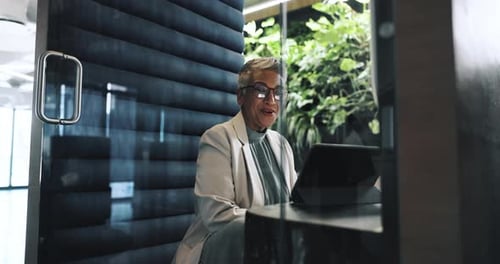 Video call, office and woman on laptop in booth for privacy in business meeting