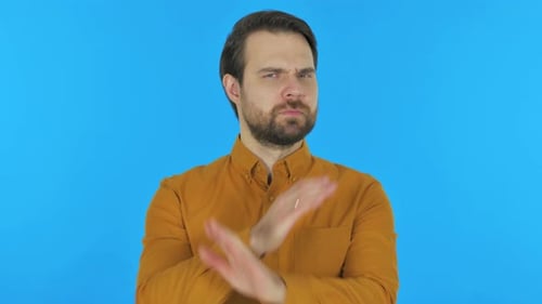 Tense Man in Denial on Blue Background, Portrait