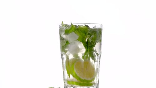 Refreshing Mojito Being Made in Glass Cup