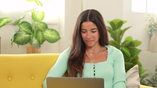 Woman Shops Online with Credit Card on Laptop
