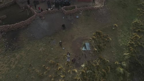 Aerial backward moving shot a samll hut over inca terrace farms beside a narrow canyon in Bolivian A