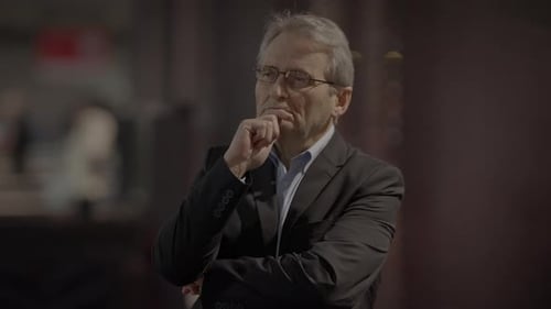Man Wearing Suit Thinking in Busy Urban Location