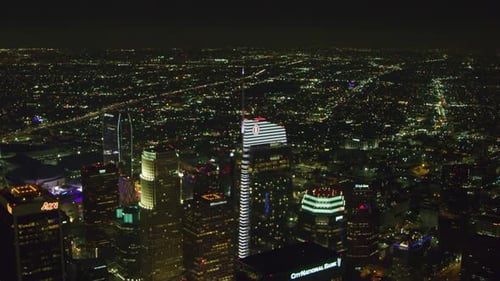 Los Angeles California downtown cityscape shimmers brightly at night aerial view