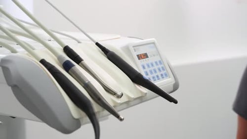 Dental Instruments in Modern Stomatology Clinic Dentist's Hand Taking Intraoral Camera to Examine