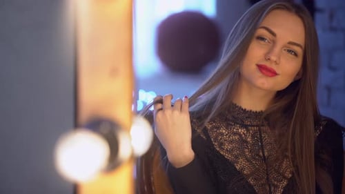 Stylish Woman Poses Near Mirror with Lights