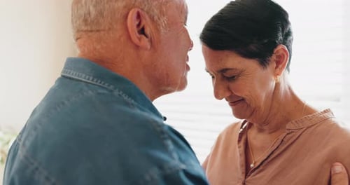 Affectionate Senior Couple Embracing at Home