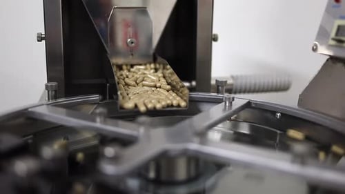 Nutraceutical diet supplement capsules drop into pill counting