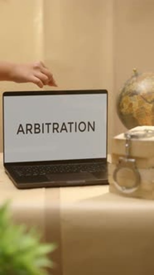 Hand Opens Laptop Showing Arbitration Text