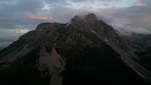 Fantastic mountain peaks glow at sunset. Red rocks at sunset. Aerial view. Mountains Komovi.