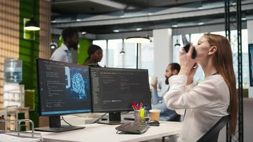 Woman Working at Computer in Modern Tech Office