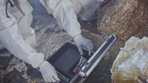 Female Scientist or Geologist Sampling a Crystal