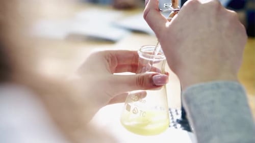 The Researcher Pouring the Liquid