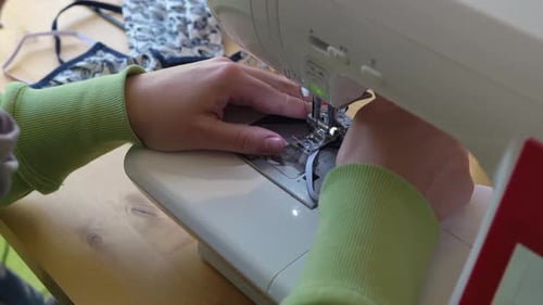 Hands Sewing a Mask on a Sewing Machine