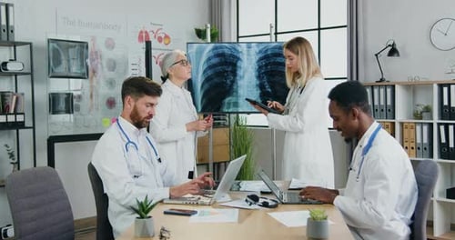 Doctors Collaborate in a Medical Office with Technology