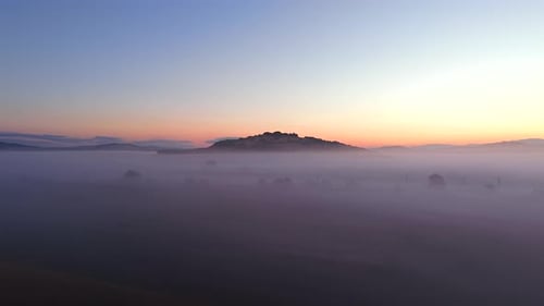 Aerial View of Sunrise Landscape with Thick Morning Fog and Golden Light