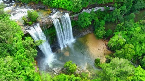 A waterfall in a beautiful tropical forest. Drone view.