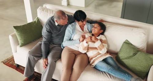 Grandparents and Grandchild Bonding Together on Couch