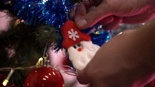 Decorating Christmas Tree with Santa Claus Ornament