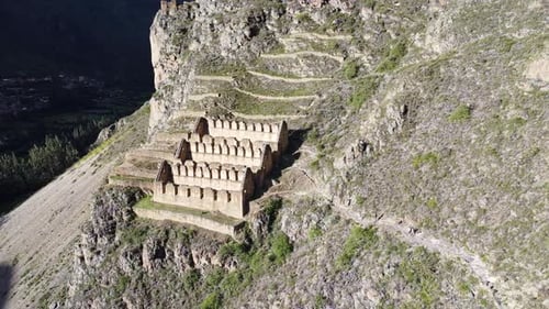 Aerial orbit establishes historic town site of Ollantaytambo cut out of hillside in Peru