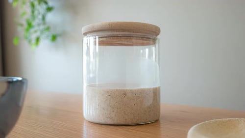 Sourdough Starter Fermenting in Glass Jar with Lid