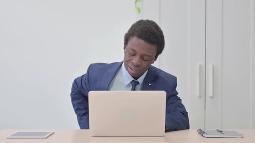 Man in Suit Working at Laptop