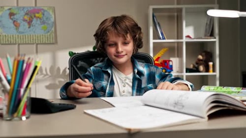 Boy Doing Homework at Desk Indoors