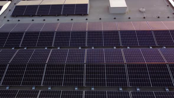 Aerial angled pullback of solar panel array, organized photovoltaic ...