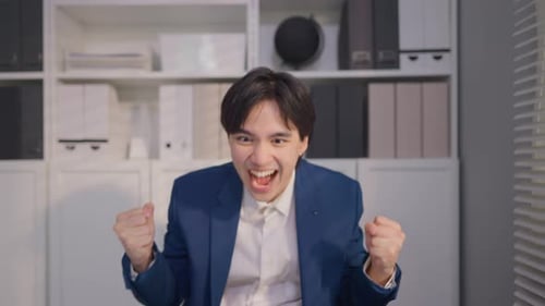 Asian young businessman checking sale order on computer in the office.