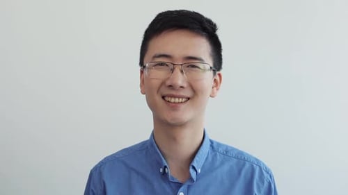 Happy Asian Businessman with Glasses Look at Camera Smile Portrait Office Suits Blue Shirt Wearing
