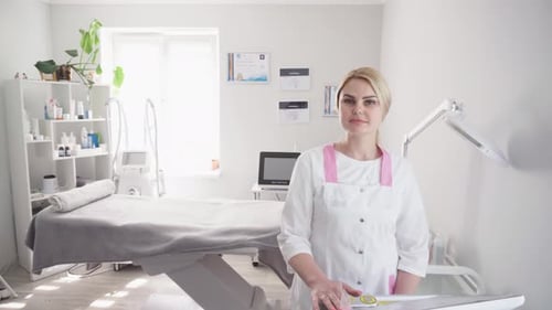 Woman in Clinic Stands in Treatment Room