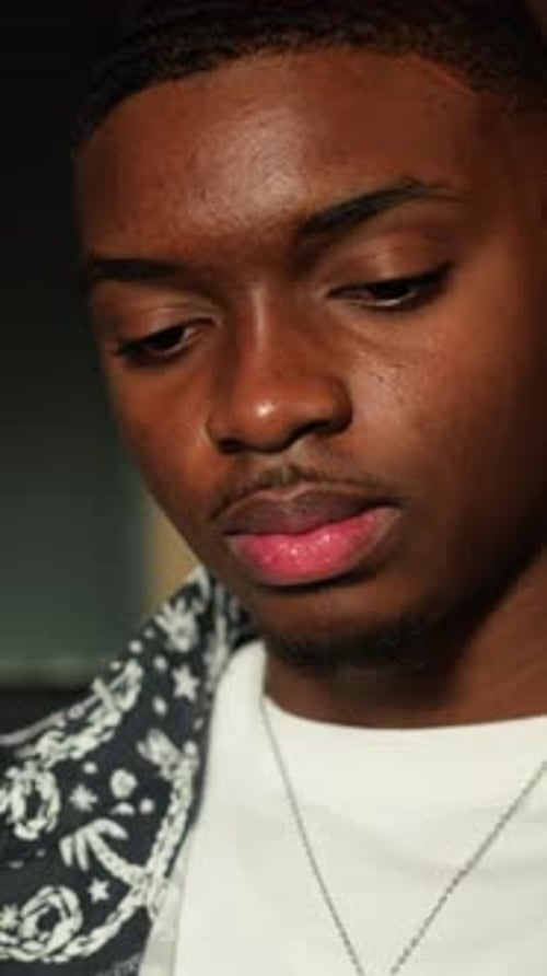 Young Man Sips From Drink With Straw