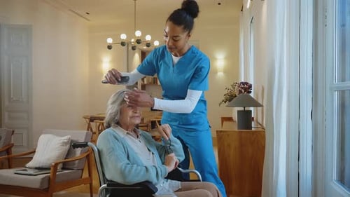 Nurse Combs Senior Woman's Hair in Bright Home
